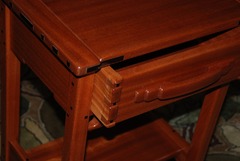 Detail of the through dovetail drawer construction and the hand carved drawer pull.